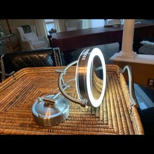 Lighted wall mountable makeup mirror .